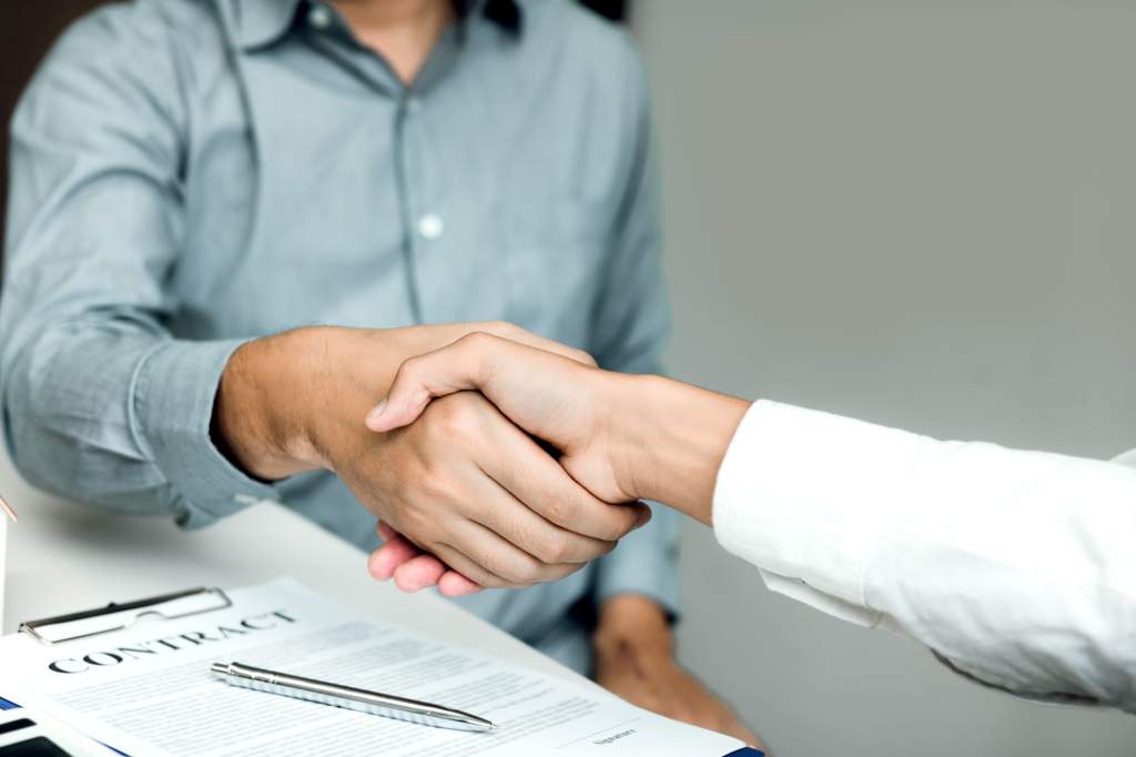 confident partnerships people shaking hands